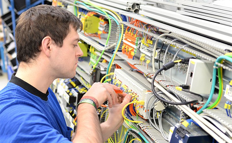 Employee works on the control cabinet